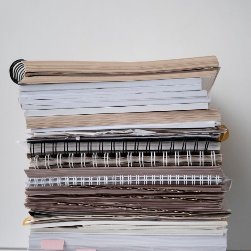 Stack of papers and notebooks printed